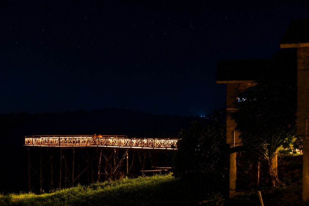 Illuminated bridge at Furomon Island Resort at night